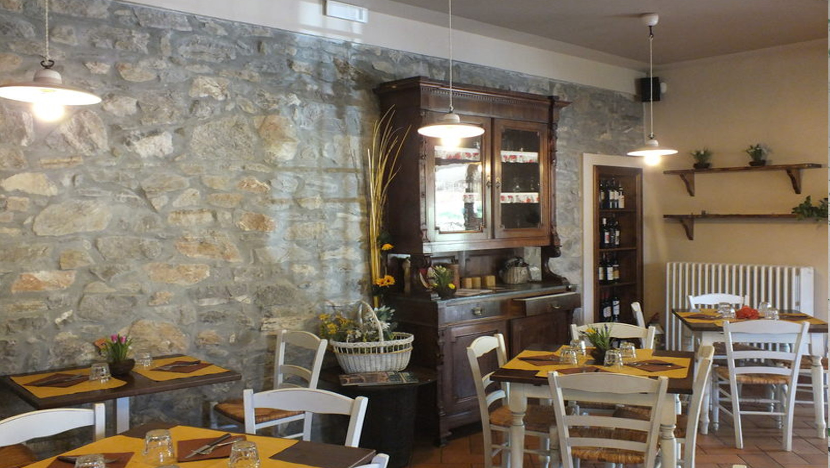 Sala interna dell'Osteria Canapino con muro in pietra